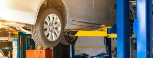 Vehicle lifted on jack stand at Taysom Tire – expert brake servicing, car repair in Orem, and full-service auto repair in Orem, Utah.